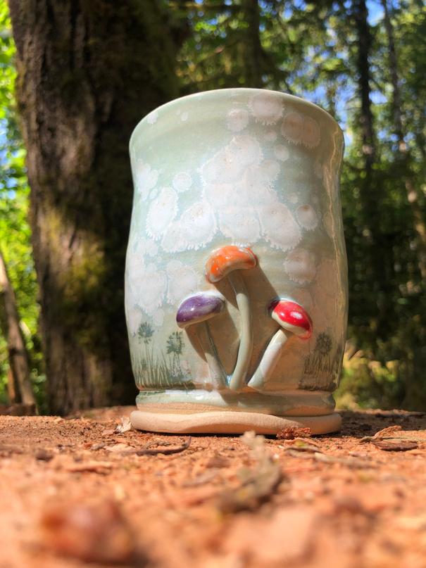 handcrafted ceramic mug with mushroom decoration